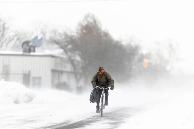 November 19, 2022, Fort Erie, ON, Canada: A man rides his bike down the street in Fort Erie, Ont., during an early winter storm that delivered high winds and large amounts of snow across southern Ontario and western New York, Saturday, Nov. 19, 2022. Fort Erie Canada  - ZUMAc35_ 20221119_zaf_c35_119 Copyright: xNickxIwanyshynx