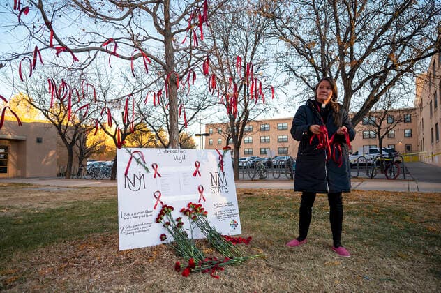 November 20, 2022, Albuquerque, New Mexico, USA: Journal .Rev. Rhonda Newby-Torres holds red ribbons at a memorial for the 19 year-old UNM student fatally shot on campus early Saturday morning. The shooting left a New Mexico State University MenÃ¢â‚¬â ¢s Basketball player wounded . Photographed on Sunday November 20, 2022 JOURNAL Albuquerque USA - ZUMAab1_ 20221120_zaf_ab1_004 Copyright: xAdolphexPierre-Louisx