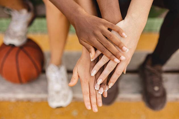 Creative Highlights Symbolbilder Multiracial friends stacking hands in sports court model released, Symbolfoto, JCCMF07890