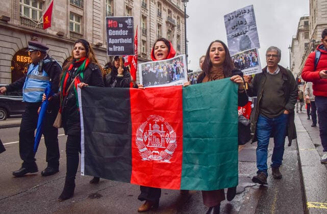 November 27, 2022, London, England, United Kingdom: Protesters march with an Afghanistan flag in Piccadilly. People marched through central London in support of women s and girlsÃ¢â‚¬â ¢ rights in Afghanistan and in response to reports that the Taliban government continues to impose oppressive laws targeting women and girls, and restricts access to education. London United Kingdom - ZUMAv130 20221127_zip_v130_013 Copyright: xVukxValcicx