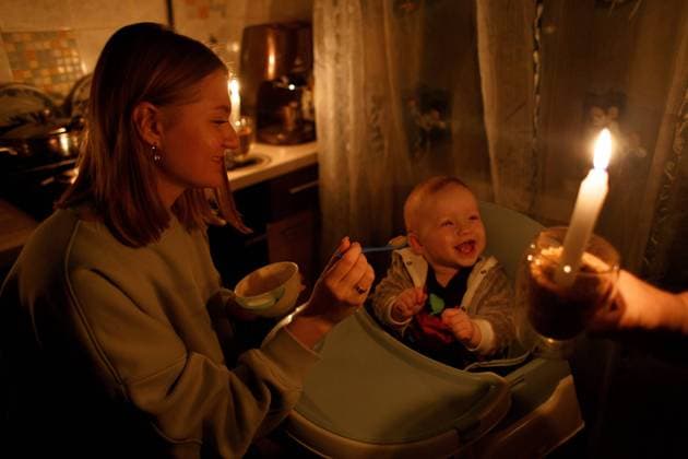 UZHHOROD, UKRAINE - NOVEMBER 28, 2022 - Yaryna, 24, feeds her son Vladyslav, who was born two days prior to Russia s full-scale invasion of Ukraine, by candlelight during a power cut caused by Russia s missile attacks against Ukraine s critical infrastructure, Uzhhorod, Zakarpattia Region, western Ukraine. Children in Uzhhorod during blackout  Copyright: xSerhiixHudakx