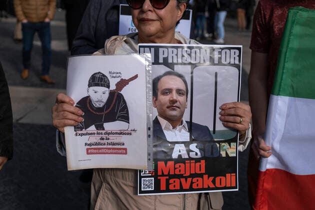 December 10, 2022, Barcelona, Catalonia, Spain: A protester holds placards during the demonstration. Coinciding with Human Rights Day, hundreds of demonstrators have demonstrated in the center of Barcelona to protest against the repression of the Iranian regime and against the death sentences of those detained during the demonstrations. Barcelona Spain - ZUMAs197 20221210_zaa_s197_142 Copyright: xPacoxFreirex