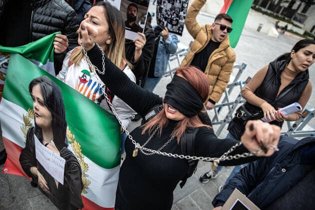 December 10, 2022, Istanbul, Turkey: A protester covered her face with black tape while holding chains during the demonstration. Mahsa Amini s death has sparked weeks of violent protests across Iran and other countries. Mahsa fell into a coma and died after being arrested in Tehran by the morality police for allegedly violating the country s hijab rules. In the trials regarding the protests, 11 people have been sentenced to death so far. Istanbul Turkey - ZUMAs197 20221210_zaa_s197_162 Copyright: xOnurxDogmanx