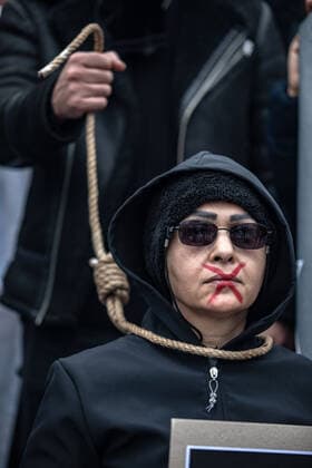December 10, 2022, Istanbul, Turkey: A demonstrator standing behind a protester with a rope around his neck performed an execution scene during the demonstration. Mahsa Amini s death has sparked weeks of violent protests across Iran and other countries. Mahsa fell into a coma and died after being arrested in Tehran by the morality police for allegedly violating the country s hijab rules. In the trials regarding the protests, 11 people have been sentenced to death so far. Istanbul Turkey - ZUMAs197 20221210_zaa_s197_177 Copyright: xOnurxDogmanx