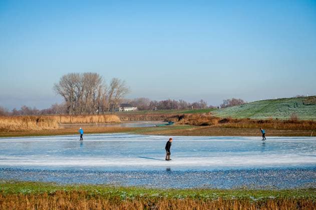 IMAGO Creative, Jahreszeit Winter, Eislaufen December 15, 2022, Nijmegen, Netherlands: A view of a part of a frozen lake with people skating on natural ice. After three days of sub-zero temperatures (around -7 degrees Celsius during the night), the water of some lakes froze. Some skaters took the chance despite the low levels of water, that provided a small part of ice surface large enough to skate, on the Oude Waal lake. Nijmegen Netherlands - ZUMAs197 20221215_zaa_s197_247 Copyright: xAnaxFernandezx