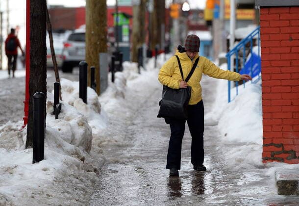 December 15, 2022, Ottawa, Ont., Canada: A pedestrian tries to navigate an ice covered sidewalk in Ottawa on Monday, January 6, 2014. A winter storm descended on Ontario on Thursday with a snowy, wet and icy commute as Environment Canada placed a majority of southern regions as well as some northern parts under snowfall and freezing rain warnings and advised against non-essential travel. Ottawa Canada  - ZUMAc35_ 20221215_zaf_c35_122 Copyright: xSeanxKilpatrickx