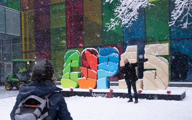 December 16, 2022, Montreal, PQ, Canada: Delegates take souvenir photos during a snowfall outside the convention centre at the COP15 UN conference on biodiversity in Montreal, Friday, Dec. 16, 2022. Montreal Canada  - ZUMAc35_ 20221216_zaf_c35_019 Copyright: xPaulxChiassonx