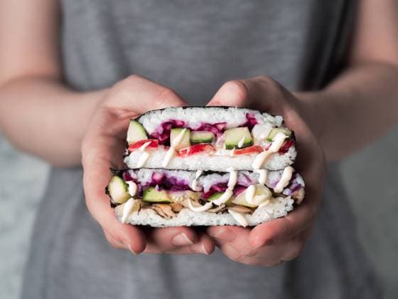 Vegan onigirazu in woman hands Vegan sushi sandwich onigirazu with mushrooms and vegetables.Healthy dinner recipe and idea. Colorful japan big roll sandwich onigirazu with red cabbage,radish,cucumber,mushrooms.Trend food.Copy space Copyright: xZoonar.com OlgaxSergeevax 14271677