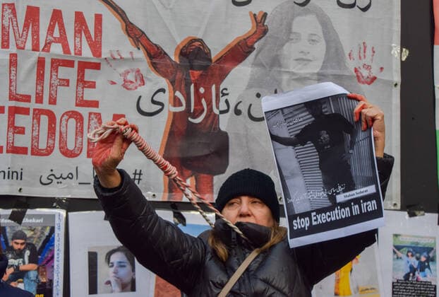 December 17, 2022, London, England, United Kingdom: A group of women staged a demonstration and performance in Piccadilly Circus in protest against the reported executions of anti-government protesters in Iran. The activists tied ropes around their necks and covered their hands in fake blood. London United Kingdom - ZUMAv130 20221217_zip_v130_005 Copyright: xVukxValcicx