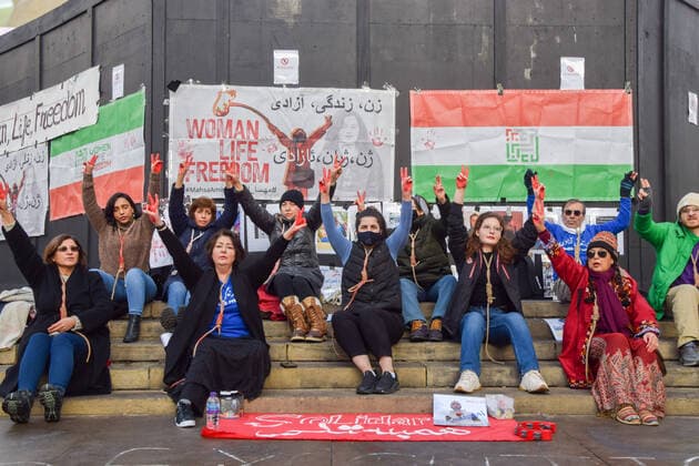 December 17, 2022, London, England, United Kingdom: A group of women staged a demonstration and performance in Piccadilly Circus in protest against the reported executions of anti-government protesters in Iran. The activists tied ropes around their necks and covered their hands in fake blood. London United Kingdom - ZUMAv130 20221217_zip_v130_008 Copyright: xVukxValcicx