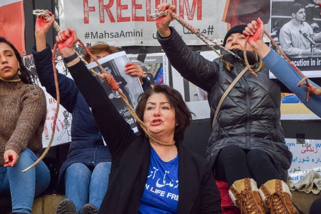 December 17, 2022, London, England, United Kingdom: A group of women staged a demonstration and performance in Piccadilly Circus in protest against the reported executions of anti-government protesters in Iran. The activists tied ropes around their necks and covered their hands in fake blood. London United Kingdom - ZUMAv130 20221217_zip_v130_010 Copyright: xVukxValcicx