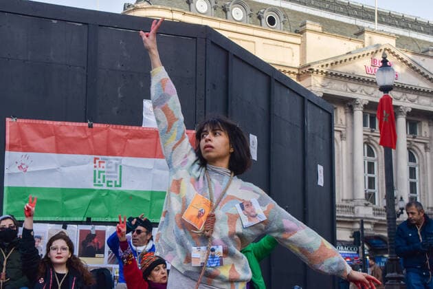 December 17, 2022, London, England, United Kingdom: A protester performs a dance with a noose around her neck. A group of women staged a demonstration and performance in Piccadilly Circus in protest against the reported executions of anti-government protesters in Iran. The activists tied ropes around their necks and covered their hands in fake blood. London United Kingdom - ZUMAv130 20221217_zip_v130_018 Copyright: xVukxValcicx