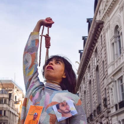 December 17, 2022, London, England, United Kingdom: A protester performs a dance with a noose around her neck. A group of women staged a demonstration and performance in Piccadilly Circus in protest against the reported executions of anti-government protesters in Iran. The activists tied ropes around their necks and covered their hands in fake blood. London United Kingdom - ZUMAv130 20221217_mda_v130_023 Copyright: xVukxValcicx