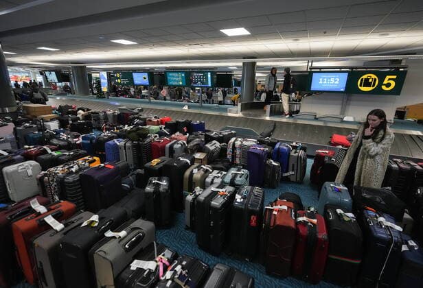 December 20, 2022, RICHMOND, BC, CANADA: A woman searches for her luggage at Vancouver International Airport after a snowstorm crippled operations leading to cancellations and major delays, in Richmond, B.C., on Tuesday, December 20, 2022. RICHMOND CANADA  - ZUMAc35_ 20221220_zaf_c35_039 Copyright: xDarrylxDyckx