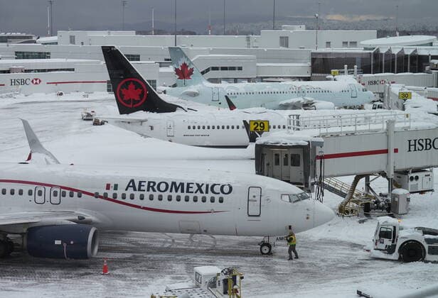 December 20, 2022, RICHMOND, BC, CANADA: Aircraft are seen parked at gates at Vancouver International Airport after a snowstorm crippled operations leading to cancellations and major delays, in Richmond, B.C., on Tuesday, December 20, 2022. RICHMOND CANADA  - ZUMAc35_ 20221220_zaf_c35_046 Copyright: xDarrylxDyckx