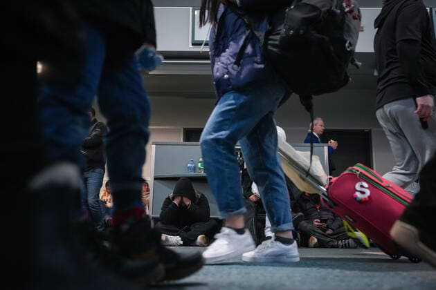 December 20, 2022, RICHMOND, BC, CANADA: People sit on the floor at Vancouver International Airport after a snowstorm crippled operations leading to cancellations and major delays, in Richmond, B.C., on Tuesday, December 20, 2022. RICHMOND CANADA  - ZUMAc35_ 20221220_zaf_c35_061 Copyright: xDarrylxDyckx