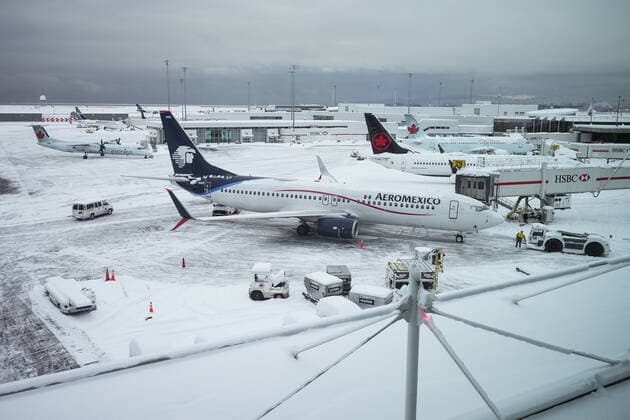 December 20, 2022, RICHMOND, BC, CANADA: Aircraft are seen parked at gates at Vancouver International Airport after a snowstorm crippled operations leading to cancellations and major delays, in Richmond, B.C., on Tuesday, December 20, 2022. RICHMOND CANADA  - ZUMAc35_ 20221220_zaf_c35_066 Copyright: xDarrylxDyckx