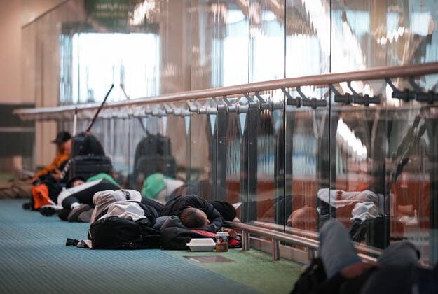 December 20, 2022, RICHMOND, BC, CANADA: People sleep on the floor at Vancouver International Airport after a snowstorm crippled operations leading to cancellations and major delays, in Richmond, B.C., on Tuesday, December 20, 2022. RICHMOND CANADA  - ZUMAc35_ 20221220_zaf_c35_071 Copyright: xDarrylxDyckx