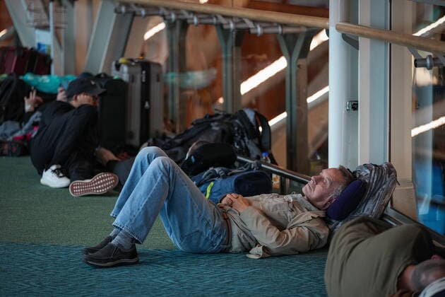 December 20, 2022, RICHMOND, BC, CANADA: A man lies on the floor at Vancouver International Airport after a snowstorm crippled operations leading to cancellations and major delays, in Richmond, B.C., on Tuesday, December 20, 2022. RICHMOND CANADA  - ZUMAc35_ 20221220_zaf_c35_072 Copyright: xDarrylxDyckx