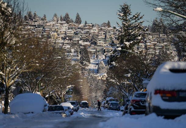 December 21, 2022, BURNABY, BC, CANADA: A person crosses a snow and ice covered road in Burnaby, B.C., on Wednesday, December 21, 2022. A snowstorm dumped more than 30 centimetres of snow in Metro Vancouver this week. BURNABY CANADA  - ZUMAc35_ 20221221_zaf_c35_040 Copyright: xDarrylxDyckx