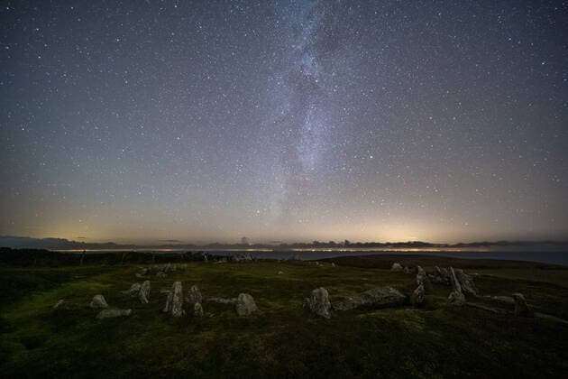 This image shows: Meayll Hill, Isle of Man by Glenn Whorrall. This chambered cairn is believed to have been built over one thousand years ago. In the sky above it, this image shows the stars of the Milky Way, the Summer triangle (bottom left of the image) and Altair in the constellation of Aquila the Eagle (left of the Milky Way). To the right of the Milky Way is the star Vega in the constellation of Lyra, the Lyre. Above left of Vega nestled in the Milky Way is Deneb, in the constellation of Cygnus, the Swan. FEATURE: Although for many of us, the long winter nights are the one negative to the Christmas season - they?re perfect if your hobby is stargazing. In fact, skies will be particularly dark over the Christmas season as there?s a Copyright: xx 52304107 EDITORIAL USE ONLY. NOT FOR USE BY NEWSPAPERS BASED IN THE UK.