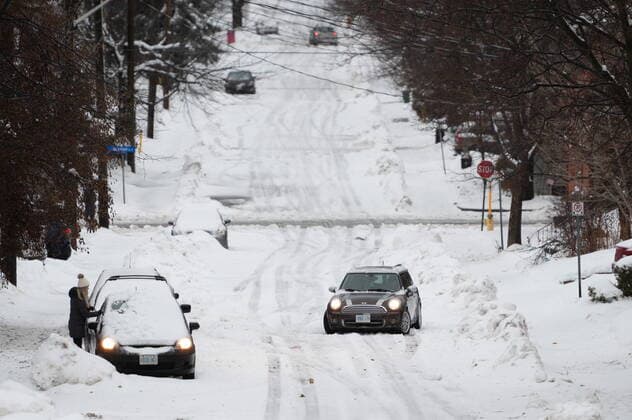 December 23, 2022, Ottawa, ON, Canada: A car sits stuck on a road in the Sandy Hill neighbourhood of Ottawa, on Friday, Dec. 23, 2022. Environment Canada has issued a winter storm warning for the region which is calling for flash freezing, icy and slippery surfaces, wind gusts and chills. Ottawa Canada  - ZUMAc35_ 20221223_zaf_c35_004 Copyright: xSpencerxColbyx