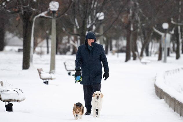 December 23, 2022, Ottawa, ON, Canada: A person walks his dog along the Rideau River in the Sandy Hill neighbourhood of Ottawa, on Friday, Dec. 23, 2022. Environment Canada has issued a winter storm warning for the region which is calling for flash freezing, icy and slippery surfaces, wind gusts and chills. Ottawa Canada  - ZUMAc35_ 20221223_zaf_c35_005 Copyright: xSpencerxColbyx