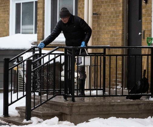 December 23, 2022, Ottawa, ON, CAN: A person lays down salt outside an apartment complex in Ottawa, as a winter storm warning is in effect, on Friday, Dec. 23, 2022. Ottawa CAN  - ZUMAc35_ 20221223_zaf_c35_013 Copyright: xJustinxTangx