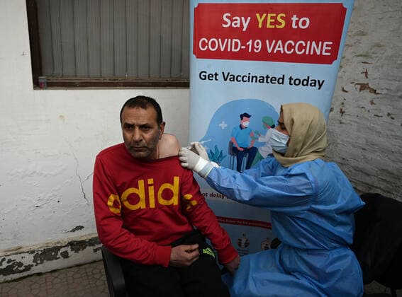 SRINAGAR, INDIA - DECEMBER 27: A man receives a shot of booster dose of COVID19 vaccine on December 27, 2022 in Srinagar, India. Reports of a massive surge in Covid-19 infections in China and apprehensions over the possibility of a spill-over effect in India has led to a sharp uptick in the vaccination intake in the country. In the past week on Friday (December 23) and Saturday, more than one lakh vaccinations were administered in India against an average of between 40,000 and 50,000 doses through most of this month.(Photo By Waseem Andrabi Hindustan Times) Amid China Scare, Covid Booster Vaccination Picks Up In India