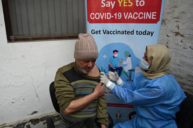 SRINAGAR, INDIA - DECEMBER 27: A man receives a shot of booster dose of COVID19 vaccine on December 27, 2022 in Srinagar, India. Reports of a massive surge in Covid-19 infections in China and apprehensions over the possibility of a spill-over effect in India has led to a sharp uptick in the vaccination intake in the country. In the past week on Friday (December 23) and Saturday, more than one lakh vaccinations were administered in India against an average of between 40,000 and 50,000 doses through most of this month.(Photo By Waseem Andrabi Hindustan Times) Amid China Scare, Covid Booster Vaccination Picks Up In India