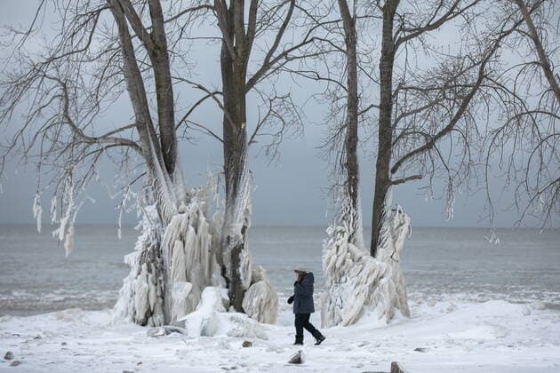December 27, 2022, Fort Erie, ON, Canada: A woman walks the shoreline of Lake Erie, near Fort Erie, Ont., Tuesday, December 27, 2022, following a winter storm that swept through much of Ontario. Fort Erie Canada - ZUMAc35_ 20221227_zaf_c35_040 Copyright: xNickxIwanyshynx