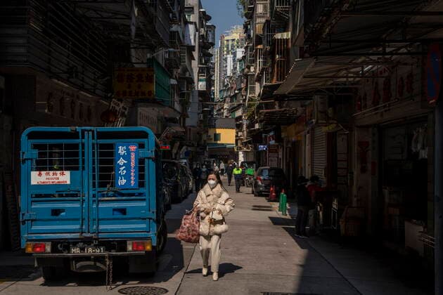 Daily Life In Macau A women wearing a face mask walks downs a street on December 29, 2022 in Macau, China. Macau Macau  Copyright: xVernonxYuenx originalFilename: yuen-dailylif221229_npIsa.jpg