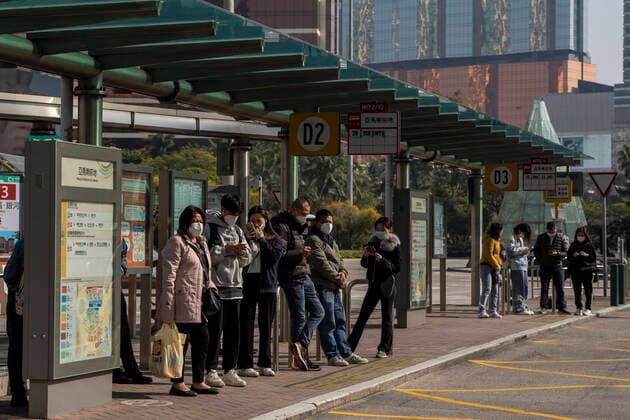 Daily Life In Macau Commuters wearing face masks while waiting for a bus at a bus stop on December 29, 2022 in Macau, China. Macau Macau  Copyright: xVernonxYuenx originalFilename: yuen-dailylif221229_npP7z.jpg