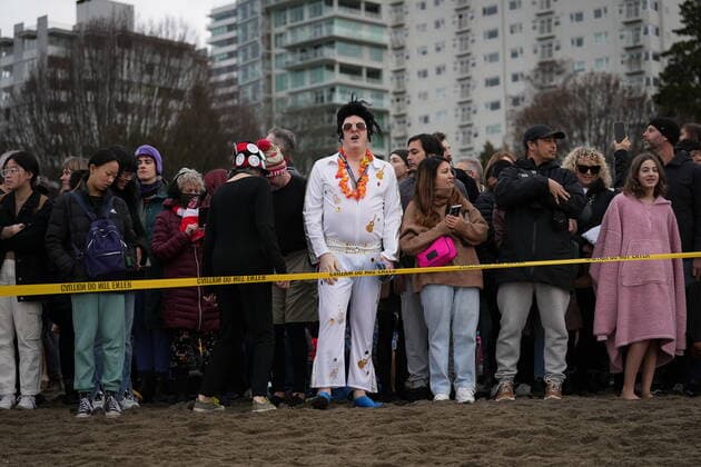 January 1, 2023, VANCOUVER, BC, CANADA: A person dressed as Elvis Presley waits with others to participate in the Polar Bear Swim, in Vancouver, B.C., Sunday, Jan. 1, 2023. This year s event was the first since 2020 after the past two years were cancelled due to the COVID-19 pandemic. According to the City of Vancouver the initial swim was in 1920 when approximately 10 swimmers participated. VANCOUVER CANADA  - ZUMAc35_ 20230101_zaf_c35_041 Copyright: xDarrylxDyckx