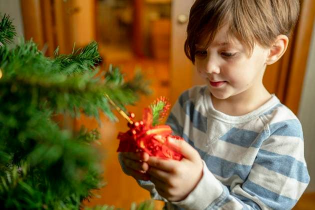 Boy looking at bell hanging on Christmas tree model released, Symbolfoto property released, ANAF00593