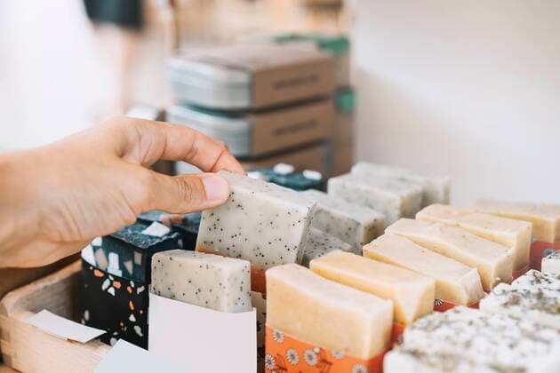 Woman picking scented soap bar at zero waste shop property released, NDEF00106