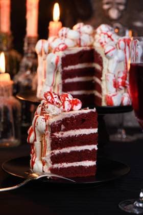 Creepy cakes on Halloween A piece of creepy cake (red velvet), decorated with meringue bones and drenched in blood. Great idea than treating guests. Close-up. Copyright: xZoonar.com MarynaxVoronovax 14466367