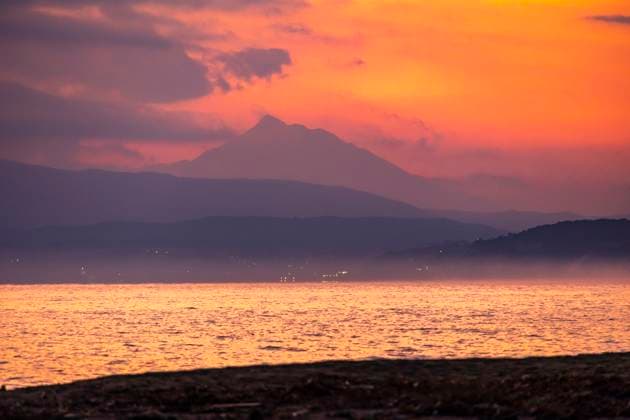 Mount Athos During The Magic Hour View of Mount Athos during the magic hour, early morning before the sunrise over the sea. Golden tones with yellow, orange, red and purple colors mixed together with the scenery, the mountain, the clouds and the sea. Mount Athos as known Agion Oros is the mountain with the highest peak at 2033m, part of the Athos peninsula, a monasticism community of Eastern or Greek Orthodox monasteries and an autonomous region in the Hellenic Republic with long history and rich nature. The Area is inscribed on the UNESCO World Heritage Site List. Ierissos, Halkidiki, Greece on January 2023 Ierissos Halkidiki Greece  Copyright: xNicolasxEconomoux originalFilename: economou-mountath230107_npS4r.jpg