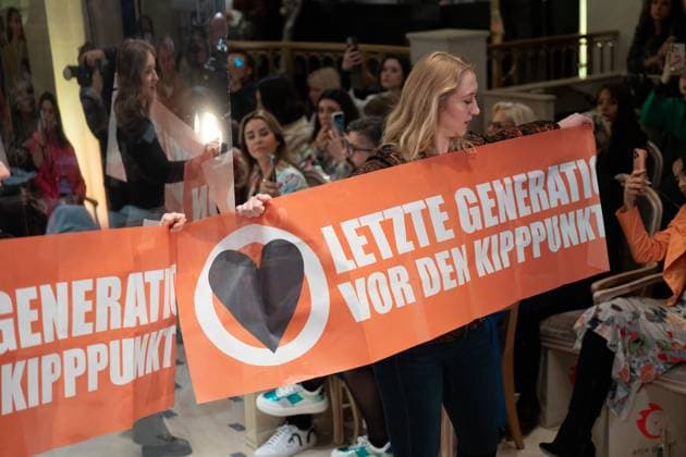 Anja Gockel Fashion Show disturbed by the Last Generation Members of the Last Generation disturbed the Fashion Show of Anja Gockel at the Adlon with banners in front of the Kipppunkt Berlin Berlin GER