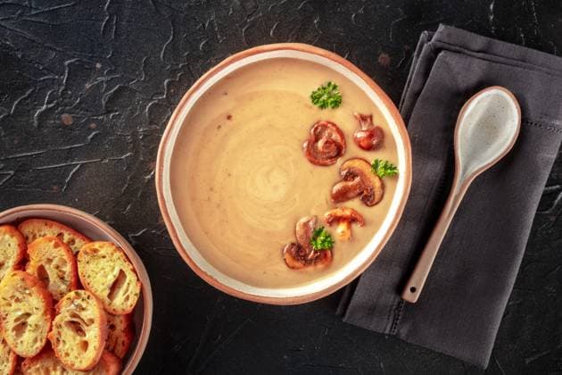 Mushroom soup in a rustic bowl with toasted bread, shot from the top Mushroom soup in a rustic bowl with toasted bread, shot from the top on a black slate background Copyright: xZoonar.com KaterinaxSolovyevax 17751116