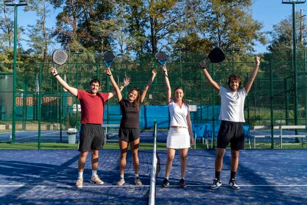 Happy men and women with arms raised standing at sports court model released, Symbolfoto property released, FMOF01595