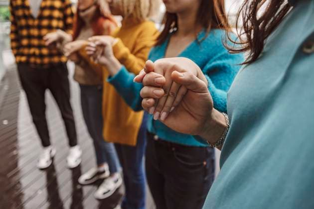 Diverse activists holding hands standing with each other at protest model released, Symbolfoto, JCCMF08639