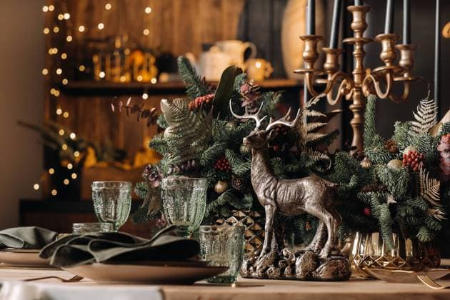 RECORD DATE NOT STATED Christmas table decoration, Banquet table with glasses before serving food, Close-up of Christmas dinner table with seasonal decorations, crystal glasses and decorative deer. , 38713514.jpg, Christmas, without people, indoors, at home, dining table, serving, deer, table, plate, tradition, trinket, red berries, seasonal decorations, selective focus, table decoration, winter, holiday, dinner, drink, food, wine, tableware, red, Yuletide, installation location, candle, Christmas dinner, plates, dishes, Cutlery, December, dining room, home life, close-up, green, glass, fir cones, new year, background, greeting card, festive, glasses, Christmas table, new year decorations, holiday season, lunch, organic, lunch time, the rest house, a plate witho