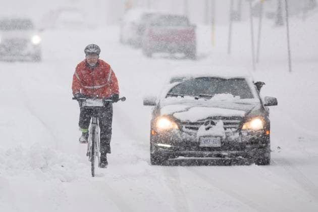January 25, 2023, Hamilton, ON, Canada: A cyclist rides along a road in Hamilton, Ont., during a winter storm, Wednesday, January 25, 2023. Hamilton Canada  - ZUMAc35_ 20230125_zaf_c35_088 Copyright: xNickxIwanyshynx