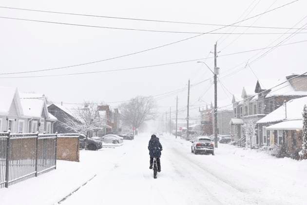 January 25, 2023, Hamilton, ON, Canada: A cyclist rides along a road in Hamilton, Ont., during a winter storm, Wednesday, January 25, 2023. Hamilton Canada  - ZUMAc35_ 20230125_zaf_c35_091 Copyright: xNickxIwanyshynx