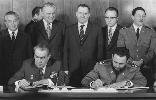 Havana, Cuba. First Secretary of the Central Committee of the Communist Party of Cuba, Prime Minister of the Revolutionary Government of the Republic of Cuba Fidel Alejandro Castro Ruz and General Secretary of the Central Committee of the Communist Party of the Soviet Union Leonid Brezhnev (R-L front) sign the Soviet-Cuban Declaration. Candidate Member of the Politburo of the Central Committee of the CPSU Grigory Romanov, First Secretary of the Central Committee of the Communist Party of Ukraine Vladimir Shcherbitsky, Minister of Foreign Affairs of the USSR Andrei Gromyko, Minister of Culture of Cuba Armando Enrique Hart Davalos and Second Secretary of the Communist Party of Cuba, Minister of the Cuban Revolutionary Armed Forces Raul Modest  22553347