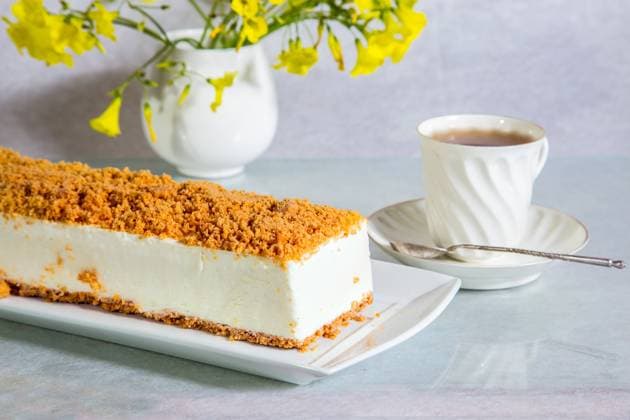 White cheesecake Gorgeous white cheesecake, sprinkled with sweet crumbs. Professional bakery. The background is porcelain cup with hot tea and vase with daisies Copyright: xZoonar.com kavramx 12083406