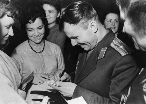 Moscow, USSR. Soviet cosmonaut, the first person in the world to make an orbital flight on the Vostok spacecraft on April 12, 1961 Yuri Gagarin signs autographs before the reception in the Kremlin dedicated to the successful completion of his space flight. Vladimir Savostyanov TASS  1452144