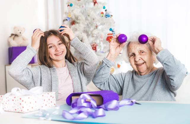 RECORD DATE NOT STATED Smiling granddaughter ang grandma playing with decorative balls at Christmas, model released, , 42203954.jpg, child, christmas, decorating, decoration, family, generation, gift, giftbox, girl, granddaughter, grandma, grandmother, handmade, helper, holiday, home, teenage, joyful, kid, merry, new year, packing, paper, present, together, woman, wrap, xmas, young, celebration, female, fun, happiness, indoor, preparing, purple, decorative, balls, holding, enjoying, head