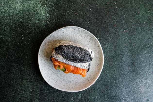 Healthy snack with sour dough and activated carbon bun and salmon fish in sandwich AnnaBogush_ID12736_386336_004 Copyright: xAnnaxBogushx Model Released